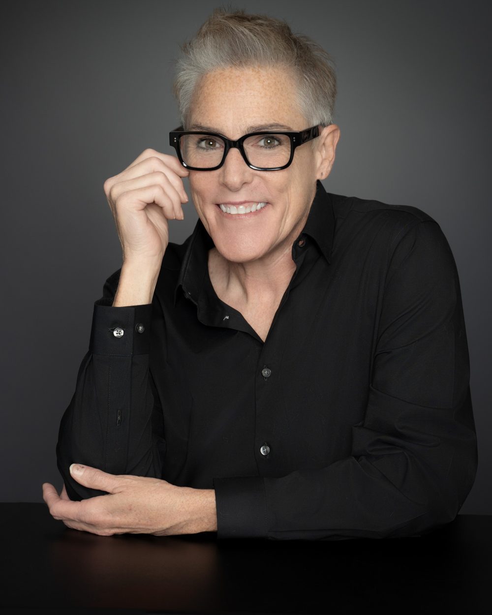 Miller Rae smiling in black glasses and a black shirt